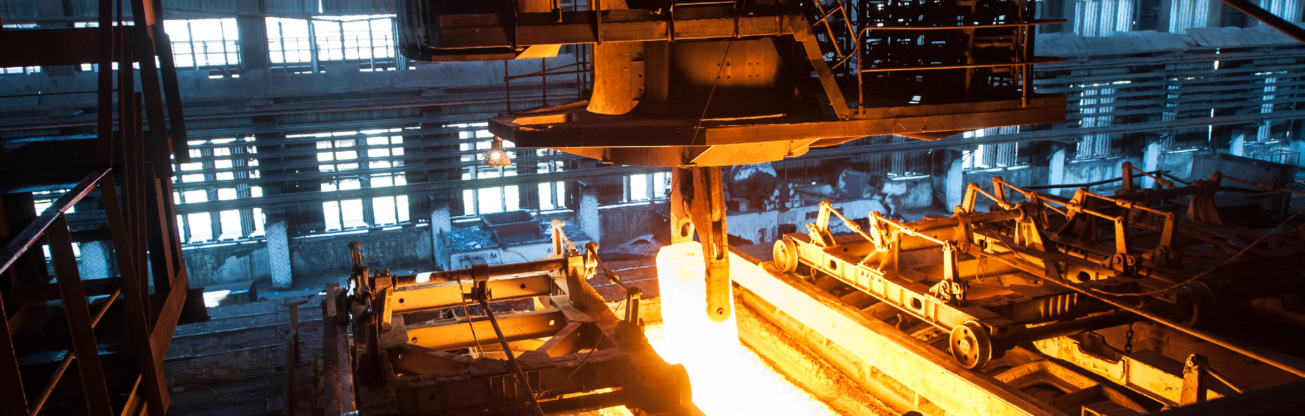 Steel mill with molten metal ladle at dusk